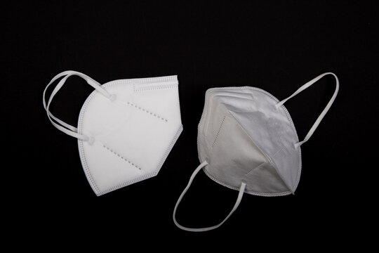 two ffp2 masks on black background. they are best best protection mask against covid-19 virus