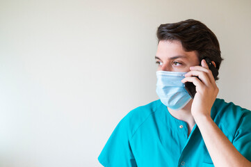 nurse with mask talking on cell phone