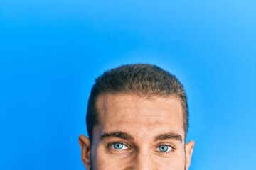 Young caucasian man showing head and half face smiling and laughing hard out loud because funny crazy joke.