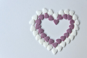 Delicious pink Valentine's Day sugar hearts and ornaments in pink, purple and white show I love you to your girlfriend and beloved people with precious diamonds and red hearts jewelry as special gift