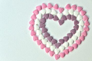 Delicious pink Valentine's Day sugar hearts and ornaments in pink, purple and white show I love you to your girlfriend and beloved people with precious diamonds and red hearts jewelry as special gift