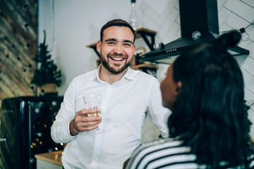 Handsome man with champagne glass at Christmas party