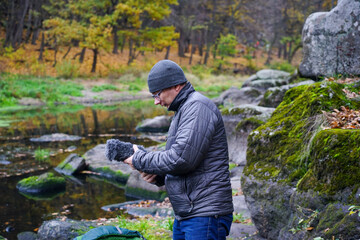 Hand holds a microphone gun to record sounds of nature. Sound technician records sounds of nature....