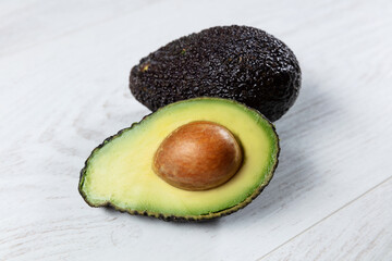 Avocado open on wooden table.