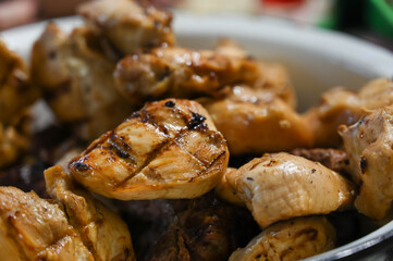 Close-up of fresh grilled meat pieces in bowl. Hot barbeque. Delicious food.