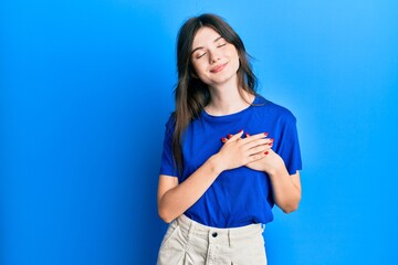 Fototapeta na wymiar Young beautiful caucasian girl wearing casual clothes smiling with hands on chest, eyes closed with grateful gesture on face. health concept.