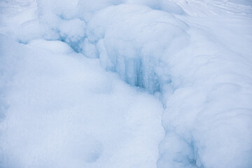 Icicles formed around frozen geyser.Winter image.High quality photo