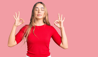 Young beautiful blonde woman wearing casual clothes relax and smiling with eyes closed doing meditation gesture with fingers. yoga concept.