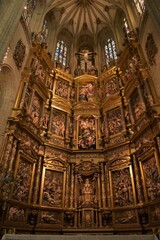 Fototapeta na wymiar Astorga, Spain - September 26, 2018: the ornate polychrome wood high altar by Gaspar Becerra at Astorga Cathedral displaying motives from the life of the Virgin Mary