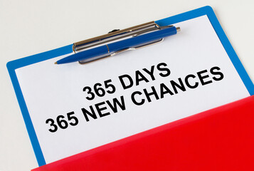 Obraz premium Clipboard with text 365 days 365 New Chances blue pen and red folder