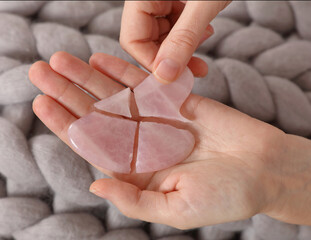 Broken Gua Sha pink Quartz stone. Skin and Body care mistakes concept