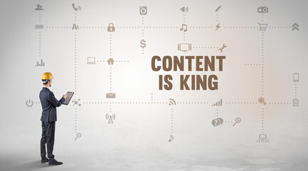 Engineer working on a new social media platform with CONTENT IS KING inscription concept