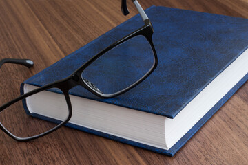 black glasses with a book

