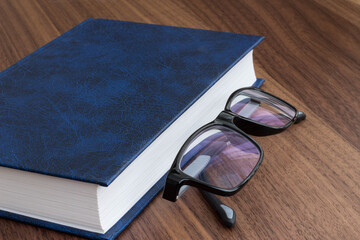 black glasses with a book
