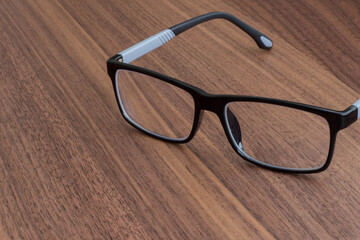 black glasses on a wooden table
