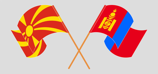 Crossed and waving flags of North Macedonia and Mongolia