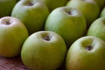 Apples stand on a wooden surface