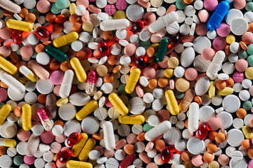 Fototapeta na wymiar a mound of colored pills, capsules and tablets