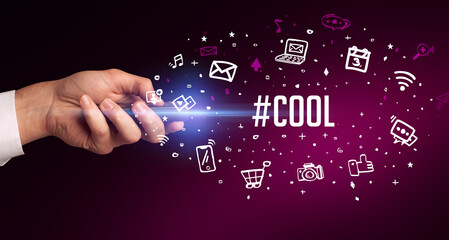 hand holding wireless peripheral with #COOL inscription, social media concept