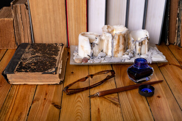 Writing nib, ink and an old book. The poet's workplace.