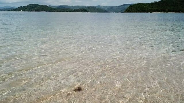  tropical vacation and island hopping concept. Gilli air island and Lombok . Indonesia, south Gili islands. Gili Asahan island. A strip of sand on the beach and blue sea with corals