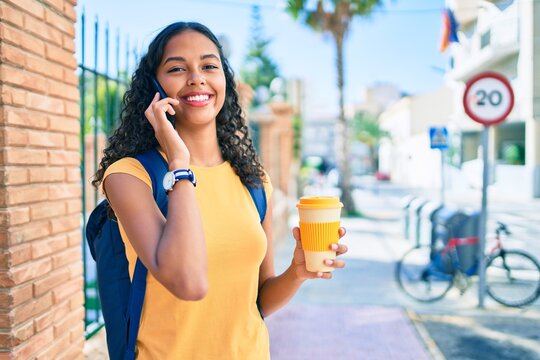 Young african american student girl talking on the smartphone at university campus.