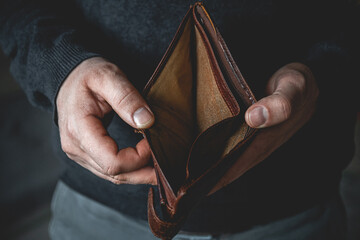 Empty wallet in the hands of a young man