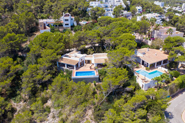 Aerial drone photo of the beautiful island of Ibiza in Spain showing a hotel and swimming pool from above