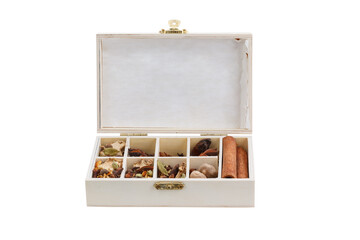 Spices for winter dishes in a wooden box on a white background. Mulled wine or ingredients for seasonal Christmas baking are aromatic spices.