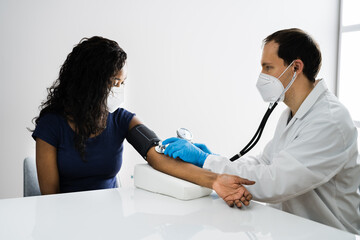 African Patient Blood Pressure Check Up Wearing Mask