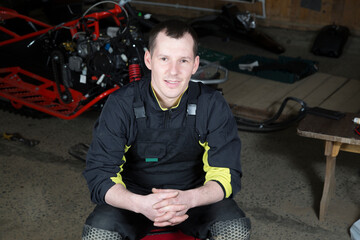 Portrait of a car mechanic.Repair and maintenance of snowmobiles.