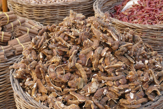 Closeup of the pile of tamarind in the wooden basket in the market in  Aswan,Egypt