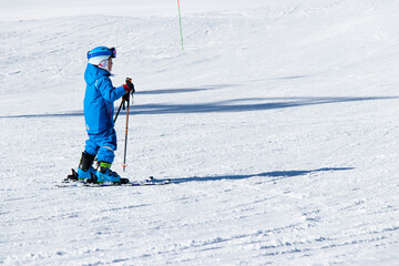 Gusar - Azerbaijan: January 2019. Child skiing in mountains. Ski race for young children. Winter sport. Little skier racing on snow