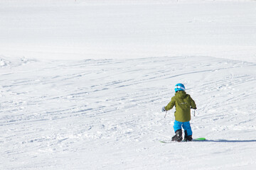 Fototapeta na wymiar Gusar - Azerbaijan: January 2019. Child skiing in mountains. Ski race for young children. Winter sport. Little skier racing on snow