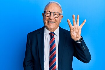 Senior caucasian man wearing business suit and tie showing and pointing up with fingers number four while smiling confident and happy.