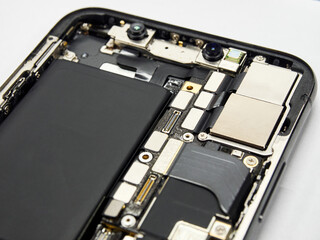 New modern smart phone internal isolated, chip, motherboard, processor, battery, cpu, frontal camera and details. Component repair. Cellphone chipset inside.