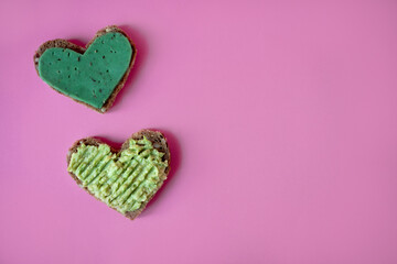 Sandwiches with avocado paste, green cheese with basilic in the shape of heart