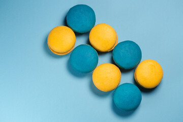 Yellow and blue macaroons on a blue background.