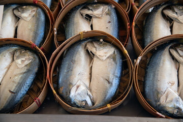 Steamed mackerel in bamboo baskets for sale at the fresh market..