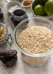 Granola raw ingredients in bowls and glass jars.
