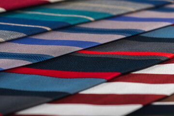 Fototapeta premium close-up view, many colorful folded ties, sloping horizon