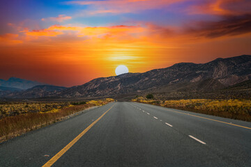 Karoo colorful sunset and a road through the valley and mountains