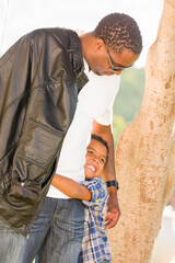 Happy African American Father and Mixed Race Son Playing At The Park