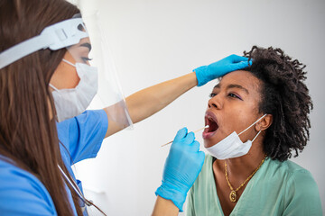 Doctor laboratory assistant in protective suit takes swab sick patient. Laboratory tests for coronavirus concept.