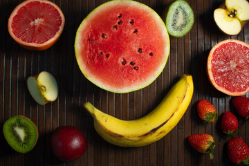 Healthy fresh red and yellow colored fruits background on kitchen table