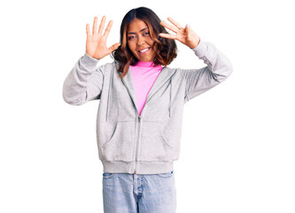 Young beautiful mixed race woman wearing casual sporty clothes showing and pointing up with fingers number eight while smiling confident and happy.