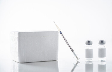 still of vaccine and ampoule on white background