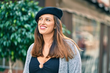 Young latin woman wearing french style standing at the city.