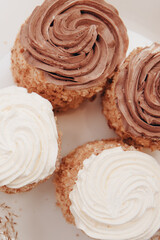 cookies on a white plate. close up of a cake. Small sweet tartlets with brown cream	