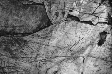 close up of lines and scratch marks on stones in black and white
